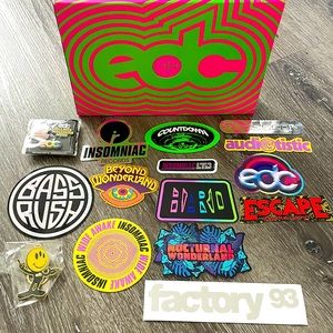 The official 2022 EDC Box with multiple stickers, pins, and a keychain.